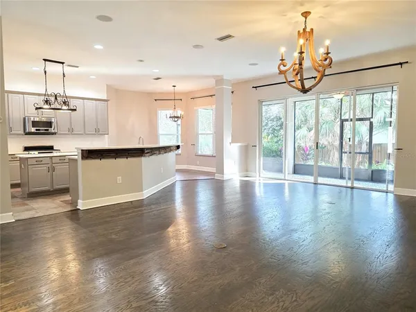 an empty room with cabinet and wooden floor