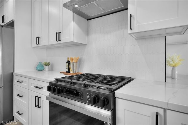 a white stove top oven sitting inside of a kitchen