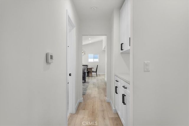 a hallway with white cabinets