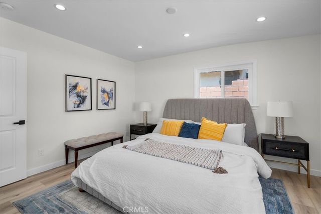 a bedroom with a bed and a lamp