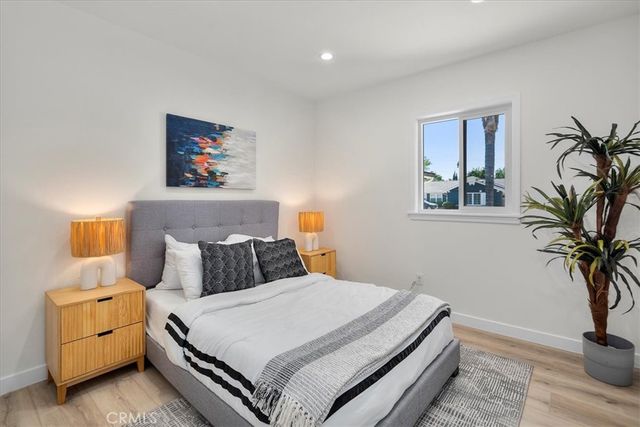 a bedroom with a bed and a potted plant