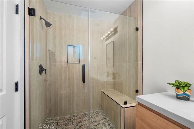 a bathroom with a granite countertop shower sink and vanity