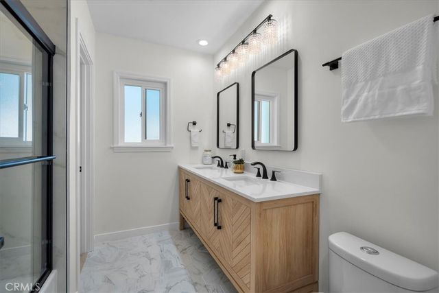 a bathroom with a sink toilet and mirror