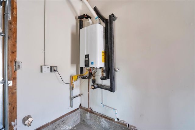 a view of white house with a yard and potted plants