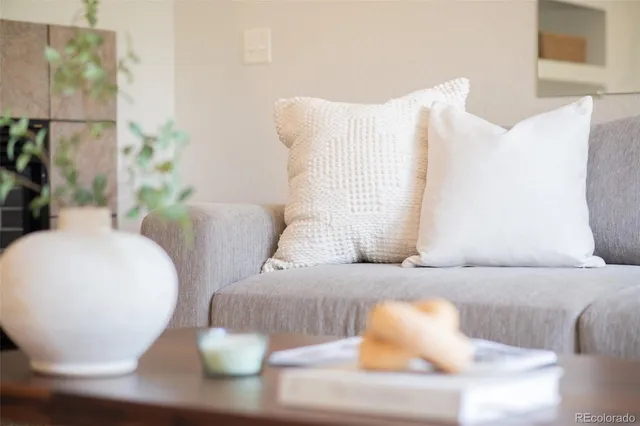 a living room with furniture and a lamp