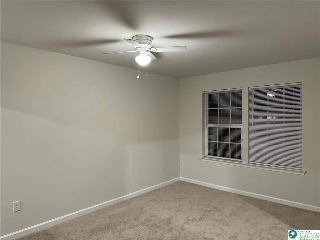 1145 Martin Road Breinigsville, PA 18031 - Photo 36 of 38 An airy bedroom with dual windows and a modern ceiling fan.