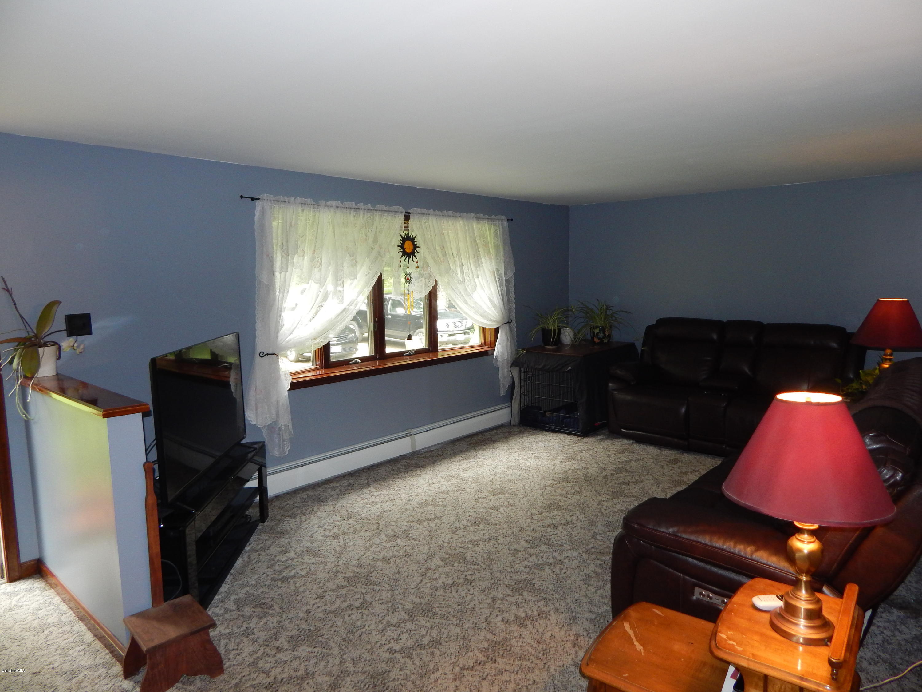 186 High St Hill Road Windsor, MA 01270 - Photo 11 of 29 a living room with furniture and a flat screen tv