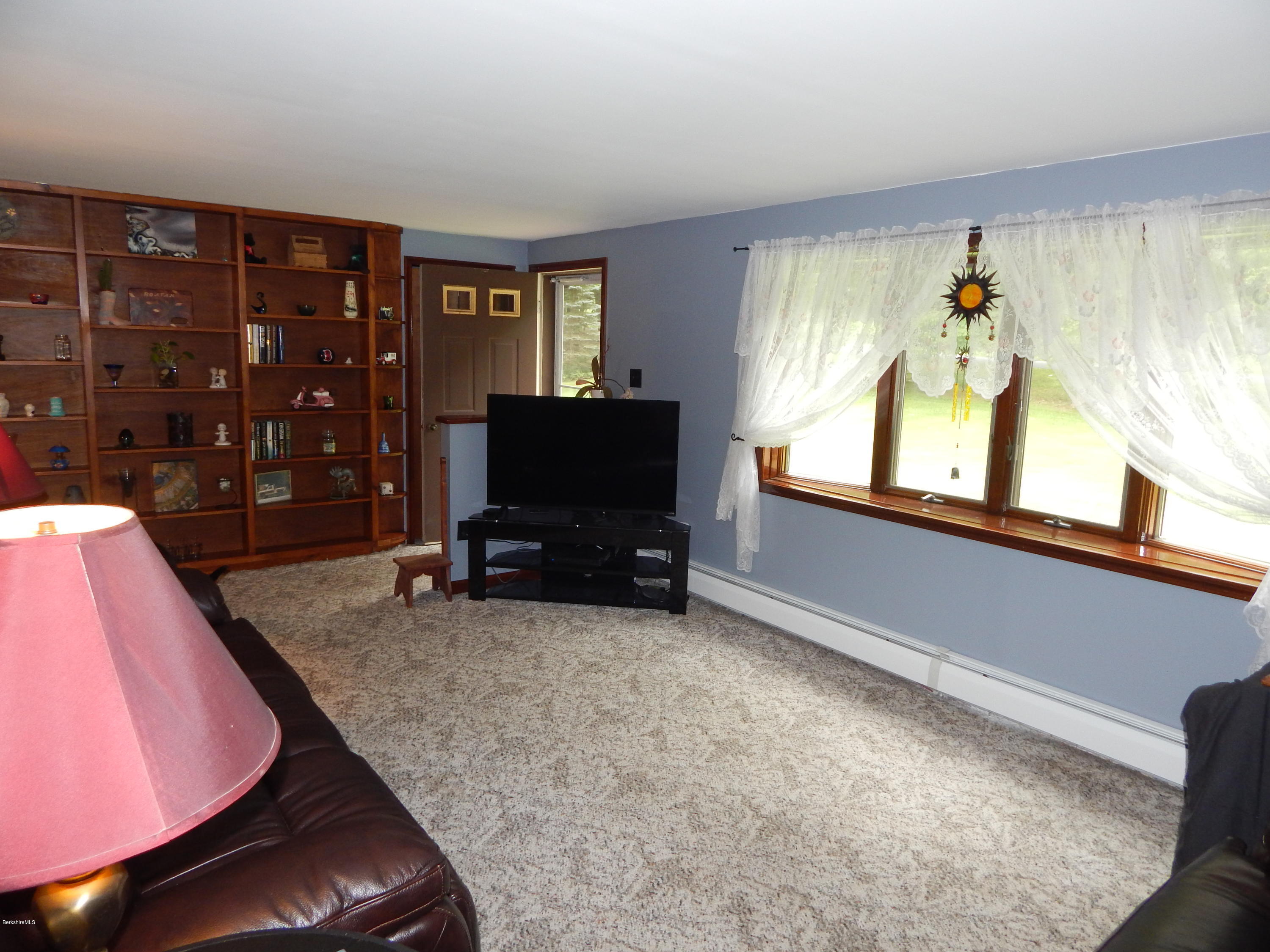 186 High St Hill Road Windsor, MA 01270 - Photo 12 of 29 a view of a livingroom with furniture and a flat screen tv