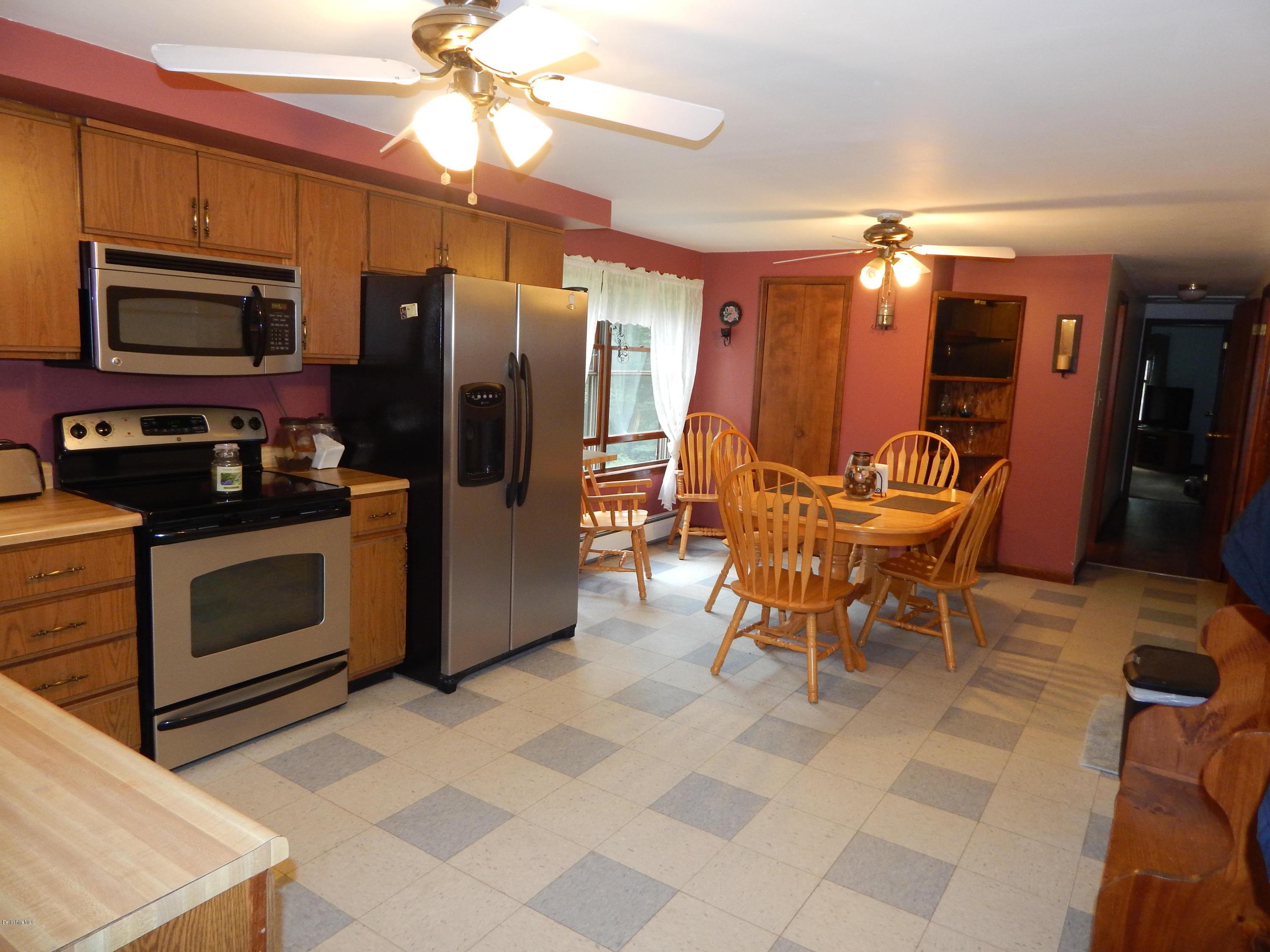 186 High St Hill Road Windsor, MA 01270 - Photo 14 of 29 a kitchen with stainless steel appliances kitchen island granite countertop a refrigerator and a stove top oven