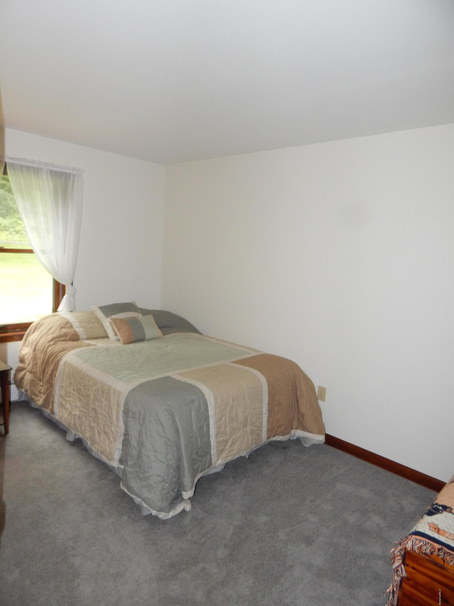186 High St Hill Road Windsor, MA 01270 - Photo 18 of 29 a spacious bedroom with a bed and a window