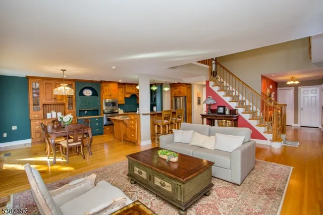a living room with fireplace furniture and a large window