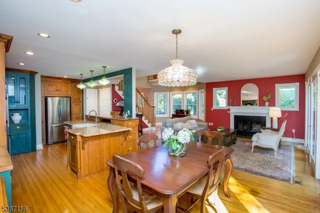 a view of a dining room with furniture a chandelier and wooden floor