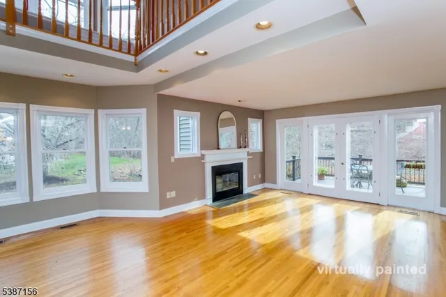 a living room with furniture a fireplace and a large window