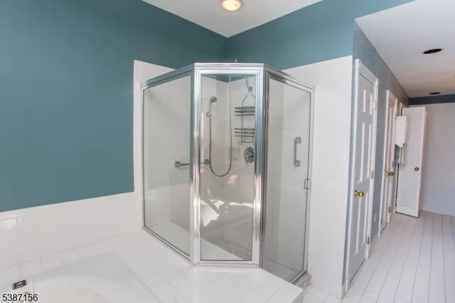 a bathroom with a glass shower door and a bathtub