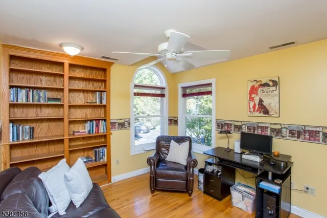 a view of a livingroom with workspace and a window