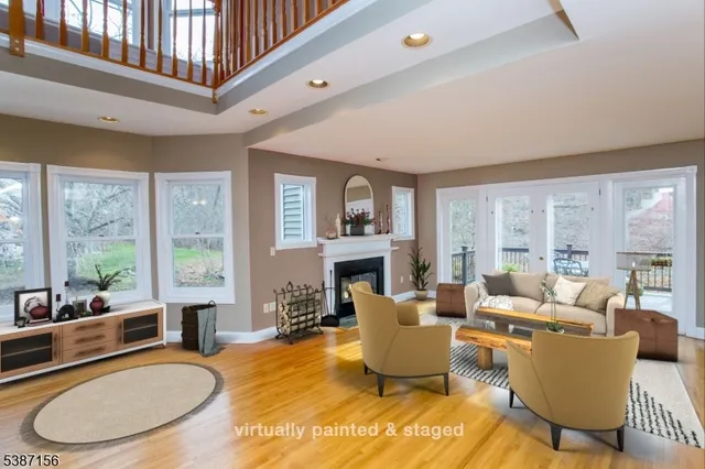 a view of an empty room with a fireplace and wooden floor