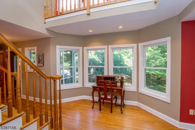 a dining room with furniture window wooden floor and front door