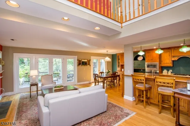 a living room with furniture dining table and a large window