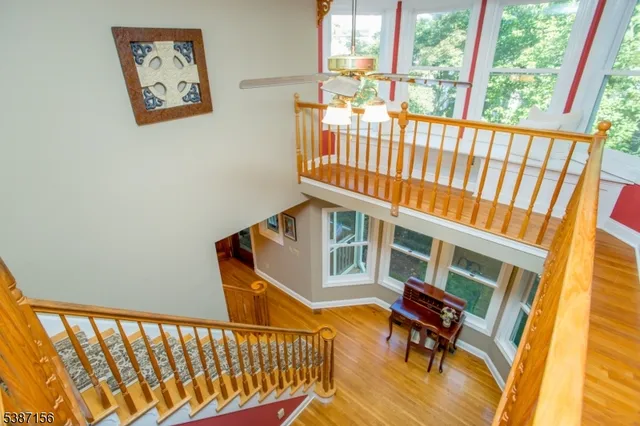 a view of a porch with furniture and wooden floor