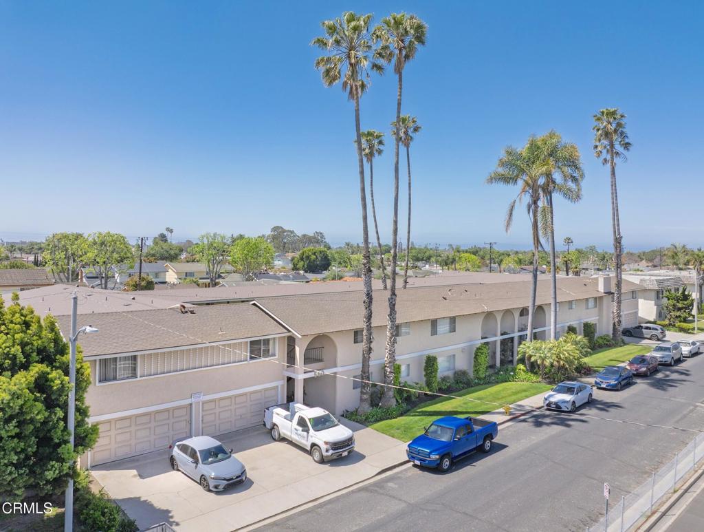a view of a patio with couches table and chairs potted plants