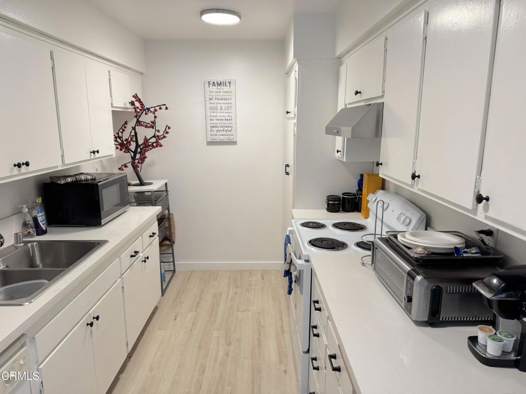 560 West Gonzales Road Oxnard, CA 93036 - Photo 12 of 13 a kitchen with a sink stove and cabinets
