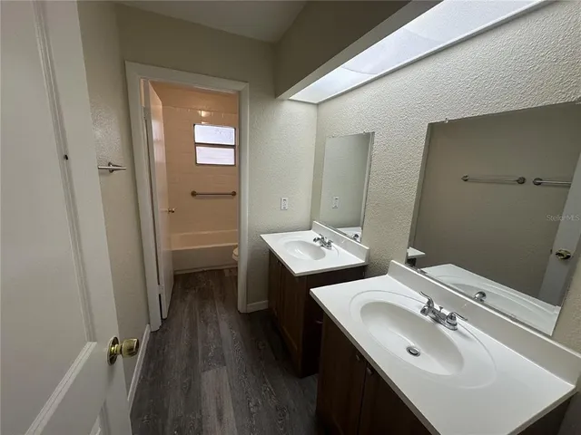 a en suite bathroom with a sink double vanity and a mirror