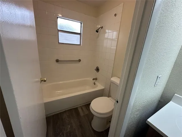 a bathroom with a toilet a sink and bathtub