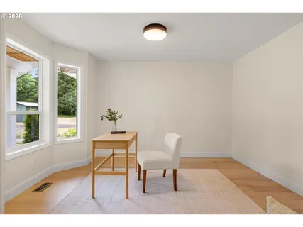 a view of a room with furniture and wooden floor