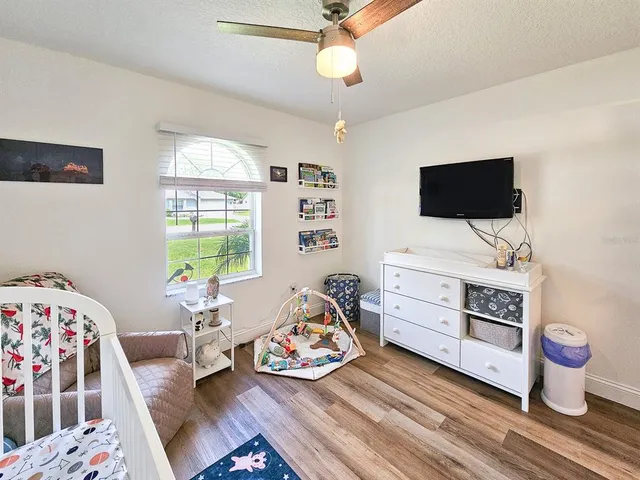 a bedroom with furniture and a flat tv screen