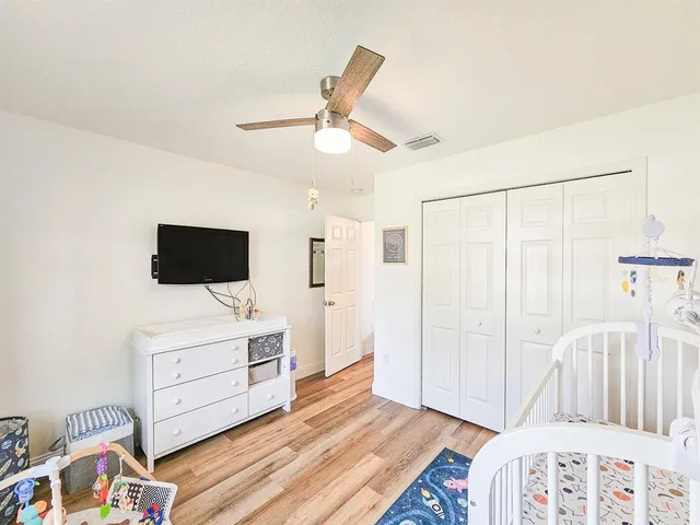 a bedroom with a bed and flat screen tv