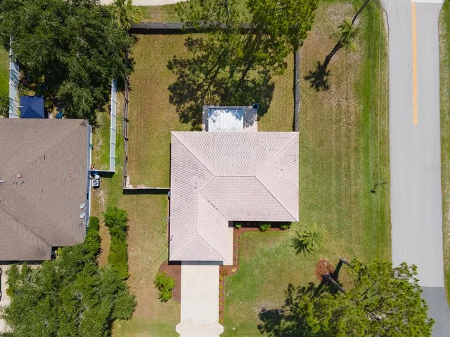 an aerial view of a house with a yard