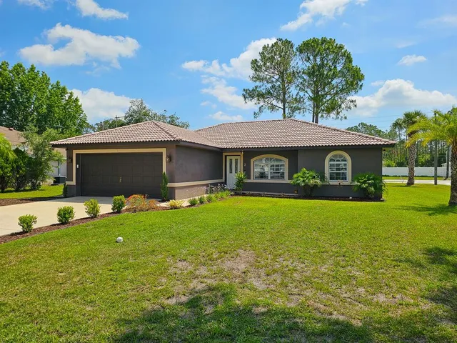 a front view of a house with a garden and porch