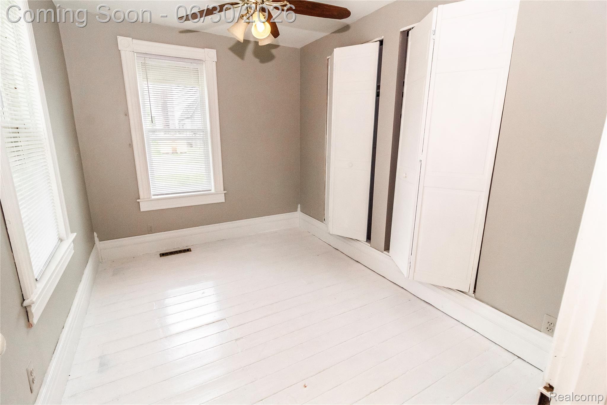8150 Norman Road Imlay City, MI 48444 - Photo 18 of 58 Room featuring white-painted wood-finish flooring, neutral wall color, and a ceiling fan with integrated lighting