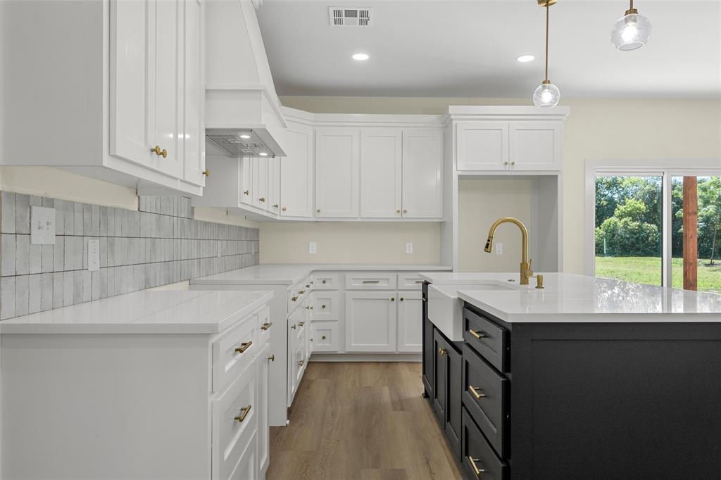 3320 North 27th Street Waco, TX 76708 - Photo 11 of 38 a kitchen with a sink window and cabinets