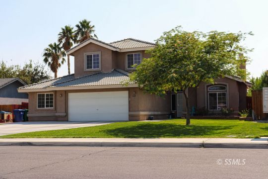 1109 Rebecca Avenue Ridgecrest, CA 93555 - Photo 2 of 50 a front view of a house with a yard and garage