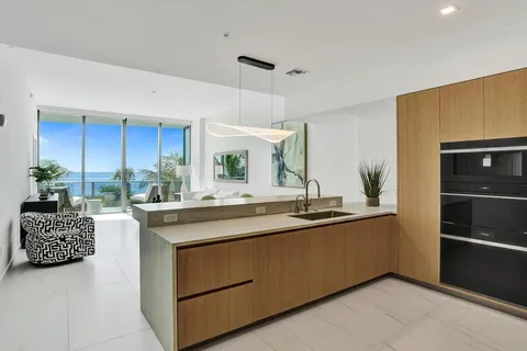 a kitchen with stainless steel appliances a sink and a refrigerator