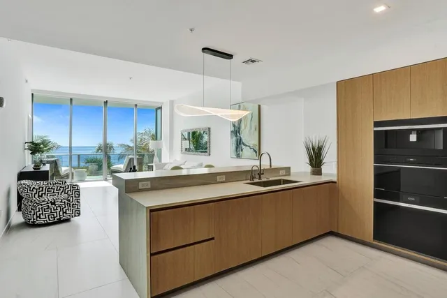 a kitchen with stainless steel appliances a sink and a refrigerator