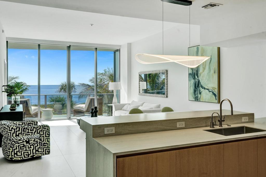 900 North Ocean Boulevard, Unit 302 Pompano Beach, FL 33062 - Photo 12 of 62 a bathroom with a double vanity sink and a mirror