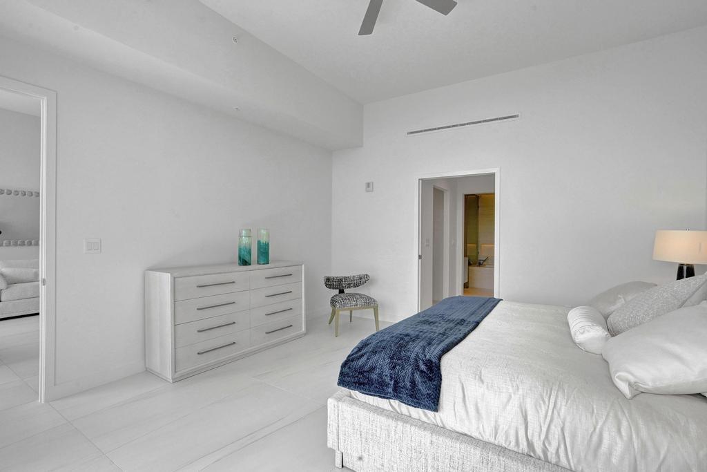 900 North Ocean Boulevard, Unit 302 Pompano Beach, FL 33062 - Photo 19 of 62 a bedroom with a bed and a dresser