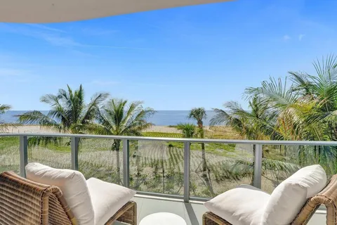 a view of a balcony with lake view and a potted plant