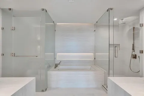 a bathroom with a tub a sink and a shower