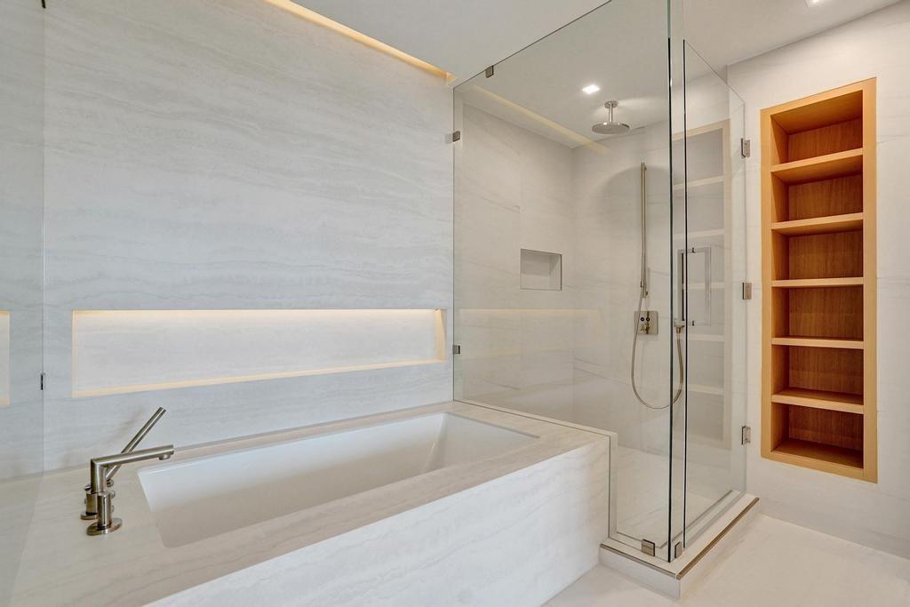 900 North Ocean Boulevard, Unit 302 Pompano Beach, FL 33062 - Photo 24 of 62 a bathroom with a bathtub and a shower