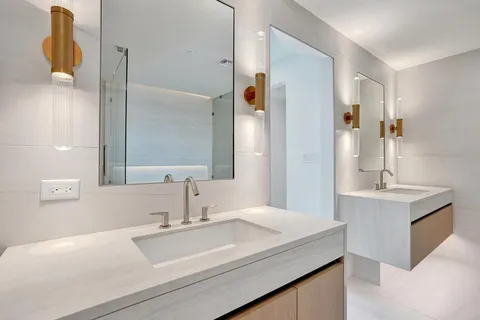 a bathroom with a sink toilet and a mirror