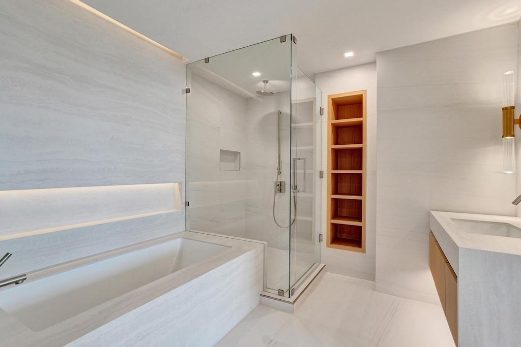 900 North Ocean Boulevard, Unit 302 Pompano Beach, FL 33062 - Photo 29 of 62 a bathroom with a tub a sink and a shower