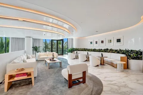 a dining room with furniture wooden floor a chandelier and a rug