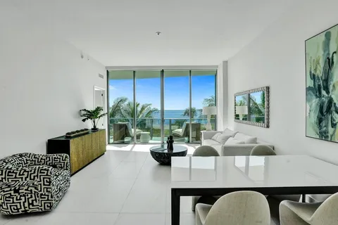 a living room with furniture lamp and window