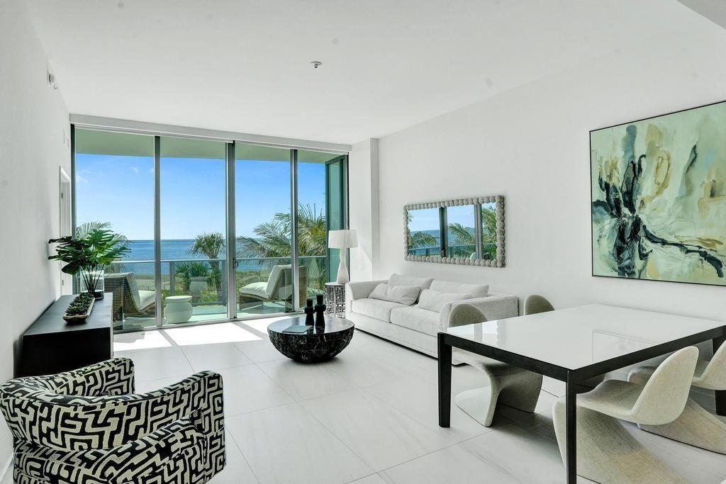 900 North Ocean Boulevard, Unit 302 Pompano Beach, FL 33062 - Photo 8 of 62 a living room with furniture lamp and window