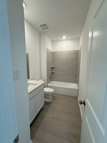 a bathroom with a toilet a sink and bathtub