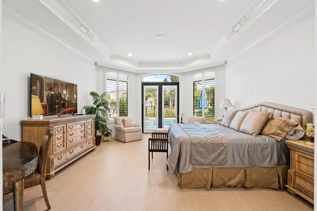 a bedroom with a large bed and a flat screen tv