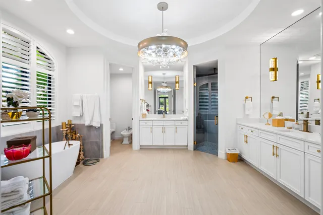 a large white kitchen with a large window